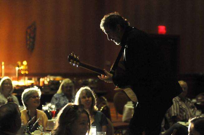 Robin Crow, founder of Dark Horse Recording in Franklin, Tenn., climbs up on a chair during his introductory guitar solo as part of his keynote talk at the Robin Crow, founder of Dark Horse Recording in Franklin, Tenn., climbs up on a chair during his introductory guitar solo as part of his keynote talk at the